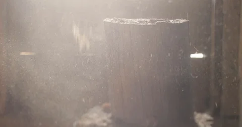Close-up footage of a log being aggressively chopped into half with sawdust Stock Footage 123218604