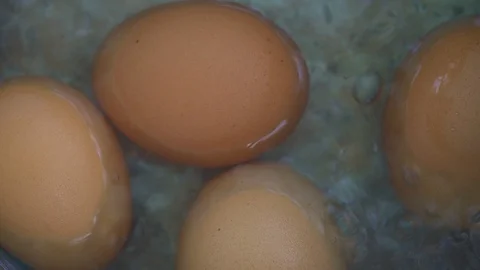 Close-up footage macro. Egg boiling in hot water Stock Footage 122371264