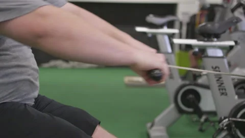 Close Footage of a Man on a Rowing Machine Stock Footage 208739851