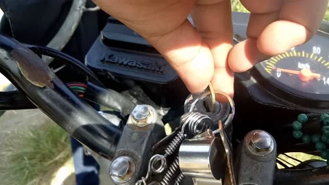 Close up footage of a man starting up the motorcycle engine. Stock Footage