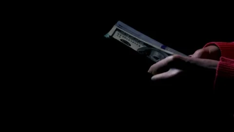 Close-up footage of a man's hand counting dollar money on a black background. Stock-Footage 336260094