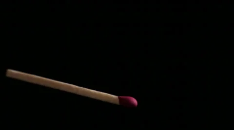 Close-Up footage of a match igniting and burning as it rotates. Vidéo 33987940
