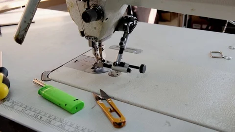 Close-up footage of professional sewing machine on manufacture Stock Footage 125478583