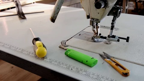 Close-up footage of professional sewing machine on manufacture Stock Footage 125478594