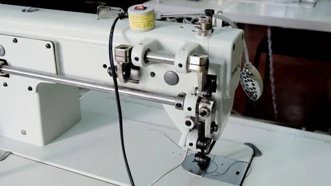 Close-up footage of professional sewing machine on manufacture Stock Footage 125478694