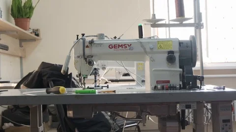 Close-up footage of professional sewing machine on manufacture Stock Footage 125478708