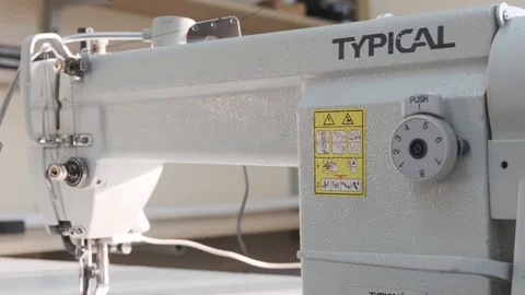Close-up footage of professional sewing machine on manufacture Stock Footage 125478735