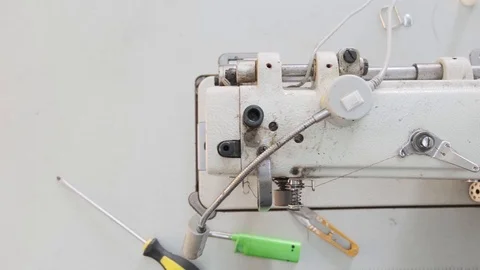 Close-up footage of professional sewing machine on manufacture Stock Footage 125478745