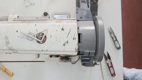 Close-up footage of professional sewing machine on manufacture Stock Footage 125478752