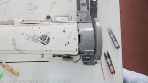 Close-up footage of professional sewing machine on manufacture Stock Footage 125478774