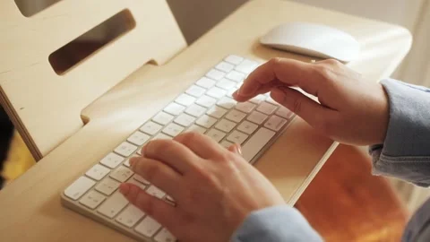 Close-up footage of a project manager's hands focused on a computer keyboard. Stock Footage 303596399