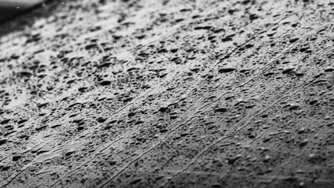 Close up footage of raindrops rolling down a car window during a rainstorm Stock Footage 213961953