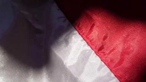 Close-up footage of the red and white silk flag under the sun. Stock Footage 317437236