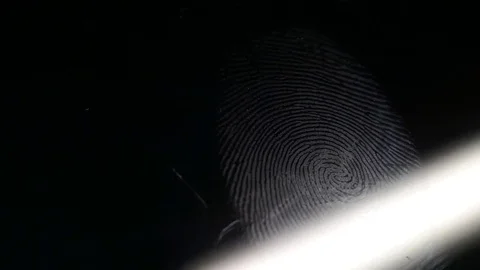 Close up footage of a scanner analyzing a fingerprint left on a surface Stock Footage 81295933