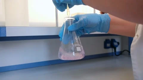 Close-up footage of a scientist adding liquid to test-tubes with a micro pipette Stock Footage 171935858