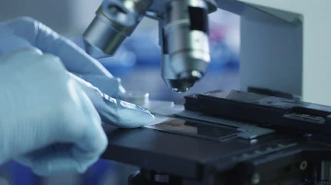 Close-up footage of a scientist setting up a microscope in a laboratory 스톡 동영상 57664720