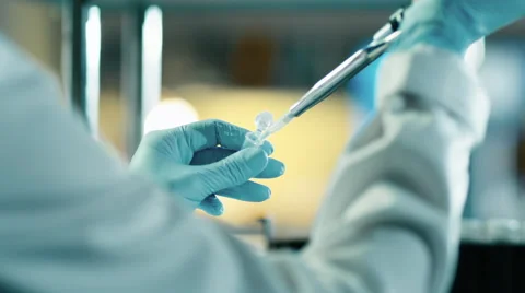 Close-up footage of a scientist using a micro pipette in a laboratory Stock Footage