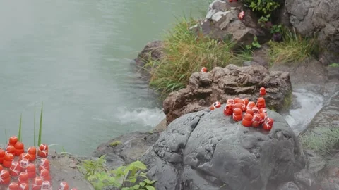 Close-up footage shows clusters of small red Daruma dolls positioned along Stock Footage 344283232