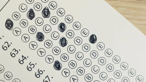 Close-up footage of a student completing a test and marking answers on paper.  Stock Footage 332665883