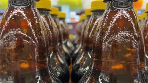 Close-up footage of tracking shot through many brown plastic bottles of drinks Stock Footage 271464695