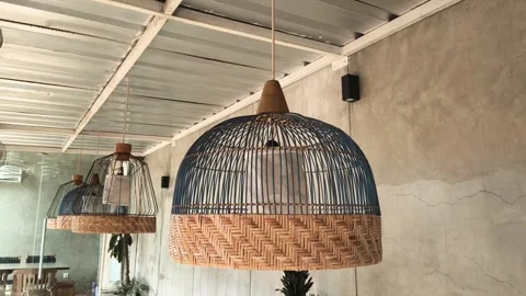 Close-up footage of a unique hanging lamp made of woven rattan. Stock Footage 319069660