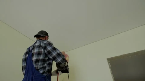 Close up footage of Workers stretch the stretch ceiling , heats the ceiling with Stock Footage 167960958