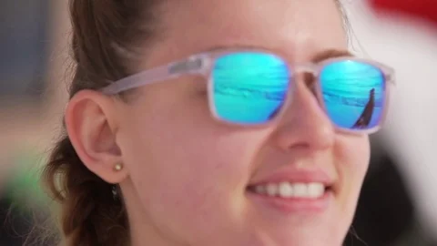 Close up footage young Caucasian female in glasses with mirrow lenses in Stock Footage