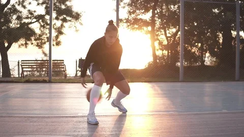 Close up footage of a young girl basketball player training and exercising Stock Footage