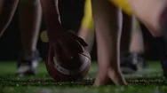 Close Up Of A Football, As Players Get Set At The Line Of Scrimmage Stock Footage