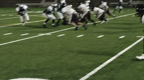 Close up of a football running back getting tackled by two defenders Stock Footage