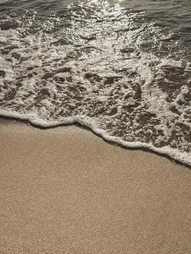 Close-up of footprints in soft sand under golden sunlight capturing a momen.. Stock Photos