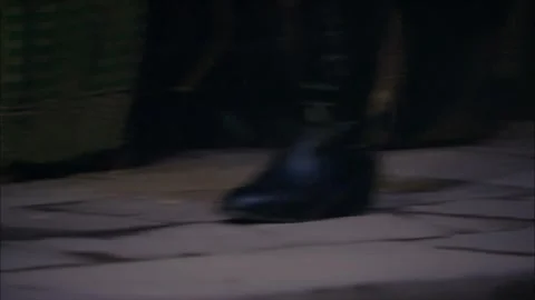 Close-up of footsteps walking at night Stock Footage 252483799