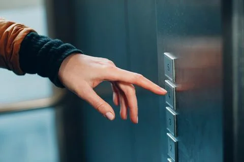 Close up of forefinger pressing the button elevator during coronavirus pandemic Stock Photos