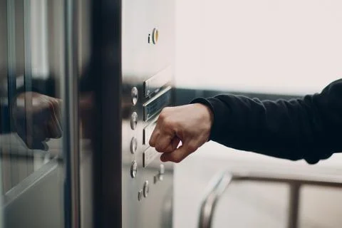 Close up of forefinger pressing the button elevator during coronavirus pandemic Foto stock