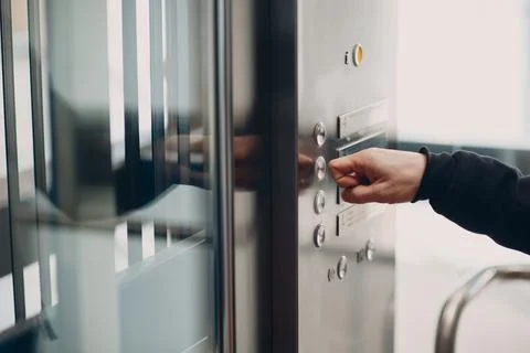 Close up of forefinger pressing the button elevator during coronavirus pandemic Foto stock
