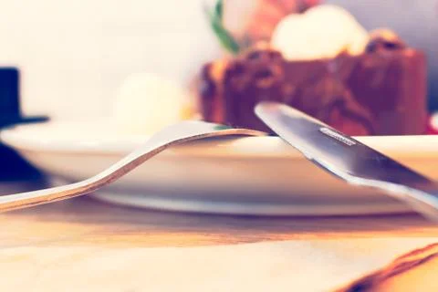Close up fork and knife on dish with icecream chocolate. Stock Photos