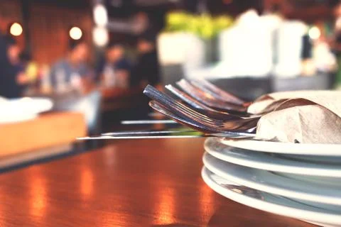 Close up fork and knife on dish in restaurant. Stock Photos