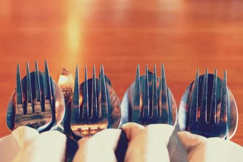 Close up fork and knife on dish in restaurant with copy space. Stock Photos