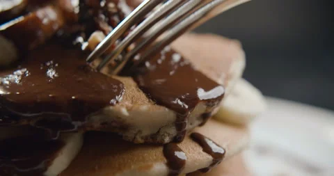 Close-up of fork breaking chocolate pancake in slow motion Stock Footage 101200880
