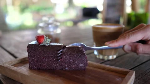 Close up of fork breaking healthy delicious vegan cake. Coffee break with Stock Footage 148069091