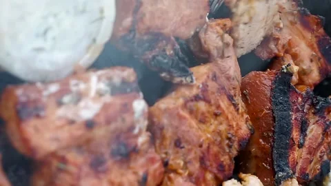 Close up fork, cooking tasty roast pork ribs with marinade onion sauce on BBQ Stock Footage 155994036