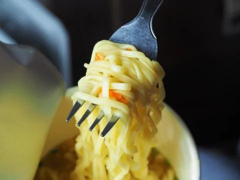 Close-up of a fork with egg noodles. Stock Photos