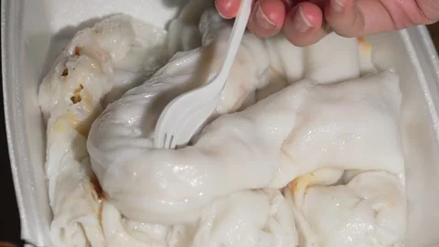 Close up fork grabs rice noodle wrapped shrimp rolls dim sum close up Stock Footage 251830031