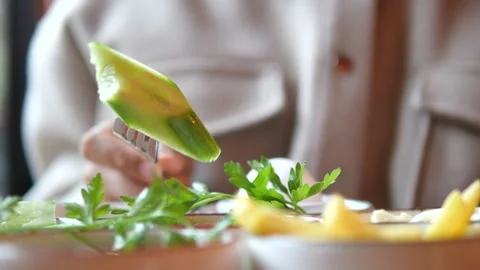 Close up of fork lifting cucumber slice during healthy breakfast meal. Stock Footage 331915038
