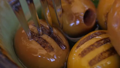 Close up of fork picking grilled olive from bowl of extra virgin olive oil Stock Footage 142419861