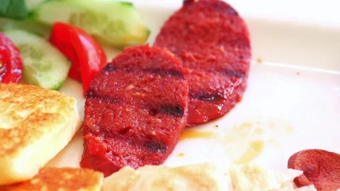 Close up of fork picking up slice of grilled turkish sausage sucuk for brea.. Stock Footage 332471253