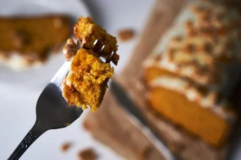 Close-up of a fork picking up a slice of homemade carrot cake. Food concept Stock Photos