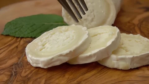 Close-up of a fork piercing and lifting goat cheese Stock Footage 267969079