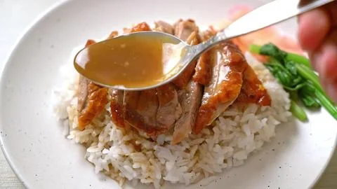 Close-up of a fork piercing a piece of meat on a white plate Stock Photos