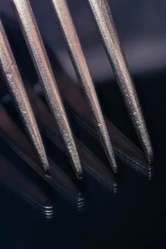 Close-up of a fork with reflection on black glass. Stock Photos